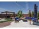 Outdoor living area with a fire pit, patio, and pergola, ideal for relaxing and entertaining in style at 25560 N 164Th Dr, Surprise, AZ 85387