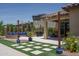 Backyard patio featuring a seating area with a grill and lush landscaping, perfect for outdoor entertaining at 25560 N 164Th Dr, Surprise, AZ 85387