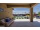 Covered patio that overlooks a sparkling pool, grass yard, and lush landscaping, perfect for entertaining and relaxation at 25560 N 164Th Dr, Surprise, AZ 85387