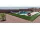 Serene backyard showcasing a pool, cozy lounge chairs, and a charming pergola for outdoor relaxation at 25560 N 164Th Dr, Surprise, AZ 85387