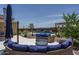 Entertainer's backyard with a pool, a patio, a fire pit, and desert landscaping, perfect for social gatherings at 25560 N 164Th Dr, Surprise, AZ 85387