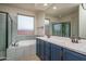 Elegant bathroom featuring a soaking tub, walk-in shower, double vanity, and modern fixtures for a spa-like experience at 25560 N 164Th Dr, Surprise, AZ 85387