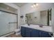 Modern bathroom featuring a double sink vanity, sleek fixtures, and glass shower at 25560 N 164Th Dr, Surprise, AZ 85387