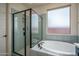 Modern bathroom with a walk-in shower, soaking tub, and stylish tile, providing a luxurious and relaxing retreat at 25560 N 164Th Dr, Surprise, AZ 85387