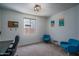 Bright bedroom with neutral walls, plush carpet, window, and fun Key West-themed wall art at 25560 N 164Th Dr, Surprise, AZ 85387