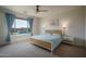 Bright bedroom with a large window overlooking the pool and patio, creating a relaxing and inviting space at 25560 N 164Th Dr, Surprise, AZ 85387