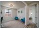 Bright bedroom with a modern desk, a large window, and a comfortable chair, perfect for relaxation or a home office at 25560 N 164Th Dr, Surprise, AZ 85387