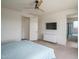 Comfortable bedroom with a mounted TV, ensuite bathroom, and a large window for natural light at 25560 N 164Th Dr, Surprise, AZ 85387