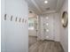 Welcoming foyer with tiled floors, a coat rack, and a view into another room at 25560 N 164Th Dr, Surprise, AZ 85387
