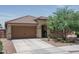 Charming single-story home featuring a two-car garage, tile roof, and low maintenance desert landscaping at 25560 N 164Th Dr, Surprise, AZ 85387
