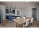 Open kitchen area with modern appliances, barstool seating, wooden table, and decorative pendant lighting at 25560 N 164Th Dr, Surprise, AZ 85387