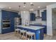 Well-lit kitchen with stainless steel appliances, modern lighting, a center island, and stylish cabinetry at 25560 N 164Th Dr, Surprise, AZ 85387