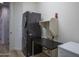 Functional laundry room featuring stacked washer and dryer, plus extra workspace at 25560 N 164Th Dr, Surprise, AZ 85387