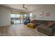 Bright living room featuring tile floors, comfortable seating, and a sliding glass door to the backyard at 25560 N 164Th Dr, Surprise, AZ 85387