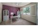 Home office with natural light, built-in shelving, and a stylish accent wall at 25560 N 164Th Dr, Surprise, AZ 85387