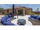 Inviting backyard patio featuring cozy seating and a stylish fire pit for outdoor entertaining at 25560 N 164Th Dr, Surprise, AZ 85387