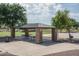 Shaded picnic area with brick columns and metal roof, perfect for outdoor gatherings at 25560 N 164Th Dr, Surprise, AZ 85387