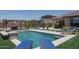 Inviting backyard pool with lounge chairs, pergola, and meticulous landscaping, creating a relaxing outdoor oasis at 25560 N 164Th Dr, Surprise, AZ 85387
