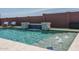 Refreshing backyard pool featuring a contemporary waterfall and comfortable lounge chairs, perfect for outdoor leisure at 25560 N 164Th Dr, Surprise, AZ 85387