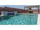 Inviting pool with a soothing waterfall feature, set against a backdrop of lush greenery and privacy fencing at 25560 N 164Th Dr, Surprise, AZ 85387