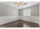 Bright bedroom with wood-look floors, chair rail, and a ceiling fan offers a comfortable living space at 2633 E Garnet Ave, Mesa, AZ 85204