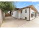 Home exterior featuring stucco walls, brown trim, and concrete patio at 2633 E Garnet Ave, Mesa, AZ 85204
