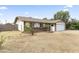 Well-maintained single-story home featuring a two-car garage, brick accents, and a spacious front yard in a suburban neighborhood at 2633 E Garnet Ave, Mesa, AZ 85204