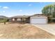 Charming single-story home featuring a two-car garage, brick accents, and a well-maintained front yard in a suburban neighborhood at 2633 E Garnet Ave, Mesa, AZ 85204
