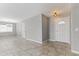 Open-concept living room with neutral paint, tile floors, and ample natural light from a large front window and front door at 2633 E Garnet Ave, Mesa, AZ 85204
