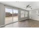 Living room with wood-look floors, sliding glass doors to the backyard, and lots of natural light at 2633 E Garnet Ave, Mesa, AZ 85204