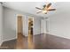 Spacious main bedroom featuring a ceiling fan, wood-look floors, and en-suite bathroom and walk-in closet at 2633 E Garnet Ave, Mesa, AZ 85204