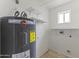 Utility room with a water heater and built-in shelving, plus washer and dryer hookups for convenience at 2633 E Garnet Ave, Mesa, AZ 85204