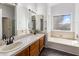 Bathroom featuring double sinks, tile counters, and tub at 2755 W Calle Del Norte --, Chandler, AZ 85224