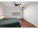 Comfortable bedroom featuring hardwood floors, modern ceiling fan, and ample natural light at 2755 W Calle Del Norte --, Chandler, AZ 85224