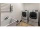 Well-equipped laundry room with a sink, drying rack, and modern washer and dryer at 2755 W Calle Del Norte --, Chandler, AZ 85224