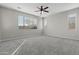 Neutral bedroom with plush carpeting, a ceiling fan, and ample natural light at 29302 N 126Th Ln, Peoria, AZ 85383