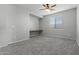 Bright bedroom with neutral walls, built-in desk and ceiling fan at 29302 N 126Th Ln, Peoria, AZ 85383