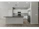 Spacious kitchen features white cabinetry, stainless steel appliances, and center island at 29302 N 126Th Ln, Peoria, AZ 85383