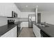 Modern kitchen with stainless steel appliances, white cabinetry, and tile flooring at 29302 N 126Th Ln, Peoria, AZ 85383