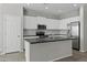 Stylish kitchen with a large island, stainless appliances, and white cabinets at 29302 N 126Th Ln, Peoria, AZ 85383