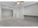 Open concept living space featuring a built-in desk and plush carpeting at 29302 N 126Th Ln, Peoria, AZ 85383