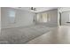 Spacious open living room with large windows, hardwood and carpet flooring at 29302 N 126Th Ln, Peoria, AZ 85383