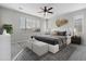 Well-lit main bedroom showcasing stylish decor, a ceiling fan, and large windows at 29302 N 126Th Ln, Peoria, AZ 85383