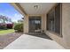 Covered patio with sliding glass door and windows, overlooking a meticulously maintained yard at 29302 N 126Th Ln, Peoria, AZ 85383