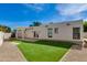 Spacious backyard featuring a pergola, well-maintained lawn, and ample space for outdoor activities at 3186 E Stella Ln, Phoenix, AZ 85016