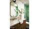 Bright bathroom with a decorative mirror, stylish sink and vanity, and a green-tiled shower at 3186 E Stella Ln, Phoenix, AZ 85016