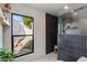Sleek bathroom with a walk-in shower, dark tile, and a garden view through a large window at 3186 E Stella Ln, Phoenix, AZ 85016
