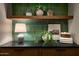 Stylish bathroom decor including a table lamp, greenery, framed artwork, and decorative containers at 3186 E Stella Ln, Phoenix, AZ 85016