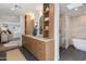 Bathroom features wood cabinets, dual sinks, decorative mirrors, and a walk-in shower with soaking tub at 3186 E Stella Ln, Phoenix, AZ 85016