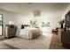 Spacious bedroom with a large rug, platform bed, and ample natural light through large windows at 3186 E Stella Ln, Phoenix, AZ 85016